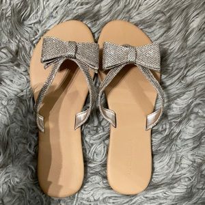 ALDO gold bow shimmer flip flops